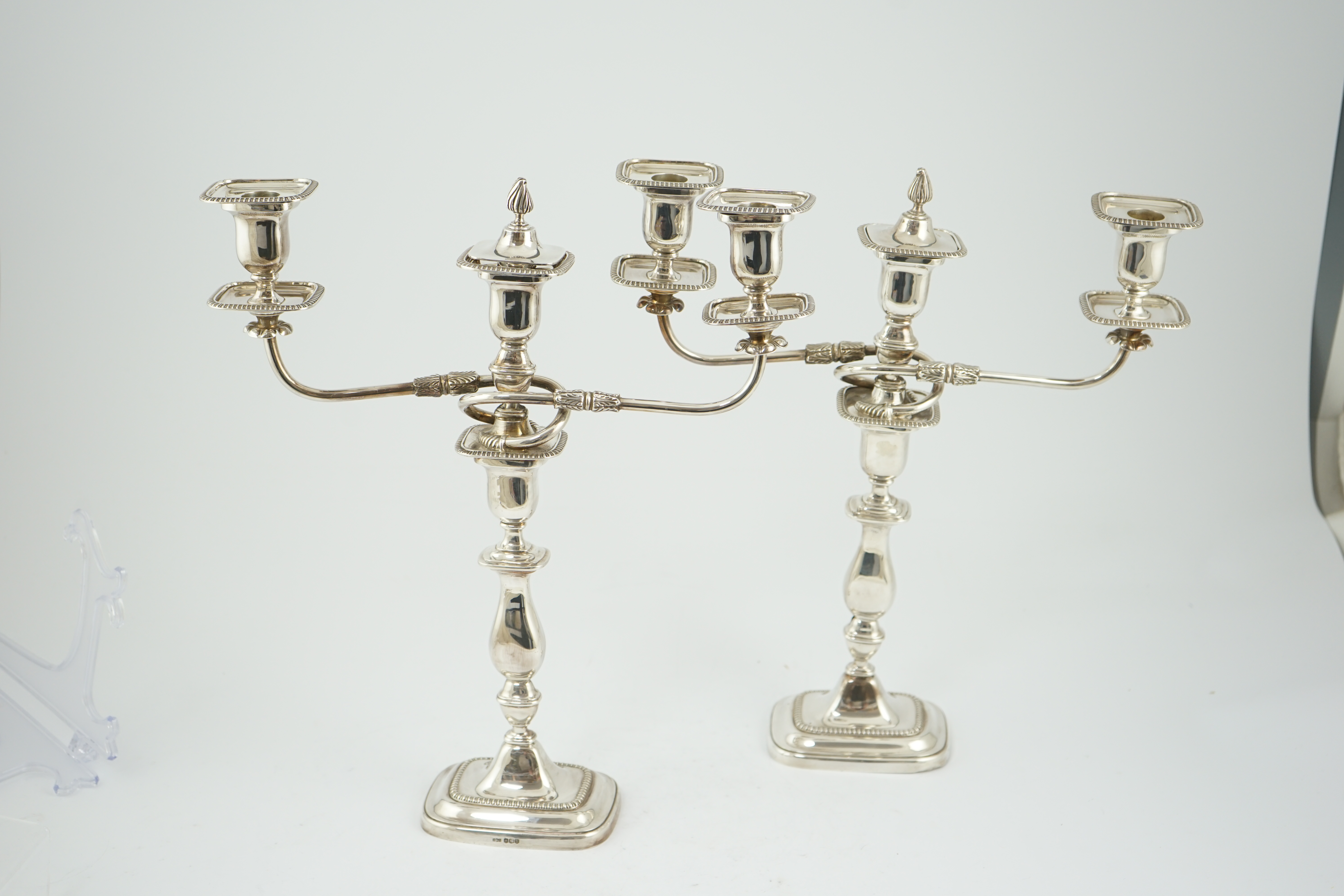 A pair of Elizabeth II silver two branch two light candelabra, by James Dixon & Sons